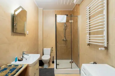 a bathroom with a shower and a toilet and a sink at Bonarka Homely Studio by BookingHost in Kraków