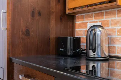 a kitchen counter with a toaster and a coffee maker at Bonarka Homely Studio by BookingHost in Kraków