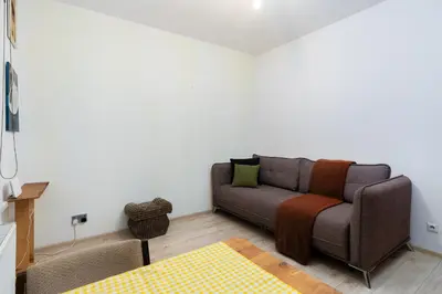 a bedroom with a bed and a kitchen with a table at Bonarka Homely Studio by BookingHost in Kraków