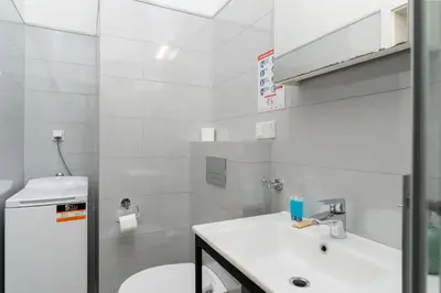 a white bathroom with a sink and a toilet at Halicka 5 Superior Studio by BookingHost in Kraków