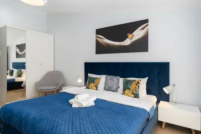 a blue and white bedroom with a blue bed at Halicka 5 Superior Studio by BookingHost in Kraków