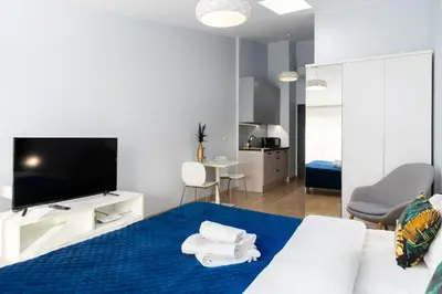 a bedroom with a bed with towels on it at Halicka 5 Superior Studio by BookingHost in Kraków