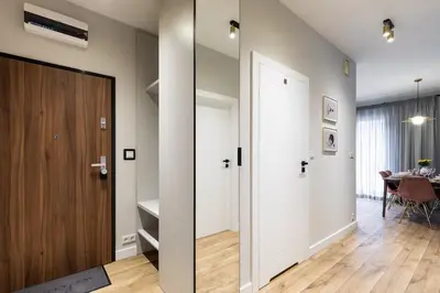 a hallway with a door and a dining room at Pink Boutique Apartment 60m2 & Garage in Kraków