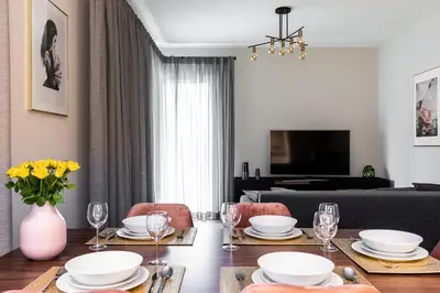 a living room with a table and a couch at Pink Boutique Apartment 60m2 & Garage in Kraków