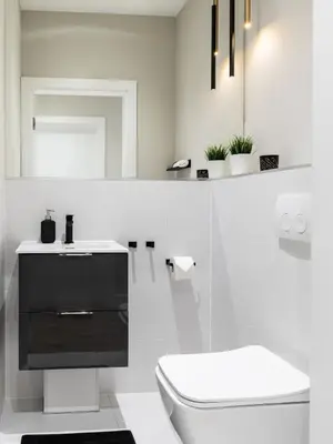 a white bathroom with a toilet and a sink at Pink Boutique Apartment 60m2 & Garage in Kraków