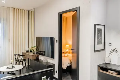 a room with a bedroom and a living room at Kościuszki Apartment N1 - AirCon - by Rentujemy in Kraków