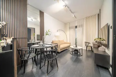 a living room with a table and chairs and a couch at Kościuszki Apartment N1 - AirCon - by Rentujemy in Kraków