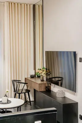 a room with chairs and tables and a large mirror at Kościuszki Apartment N1 - AirCon - by Rentujemy in Kraków