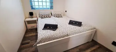 a bed with two black and white pillows on it at Quiet Apartment in Oświęcim
