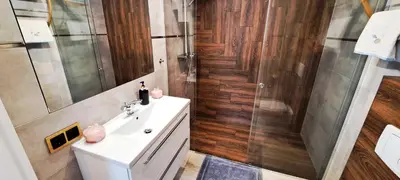 a bathroom with a sink and a shower at Quiet Apartment in Oświęcim