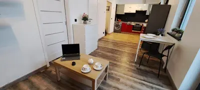 a living room with a couch and a table at Quiet Apartment in Oświęcim