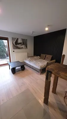 a bedroom with a bed and a table in it at Odpoczynek w Parku, Free Parking!! in Kraków