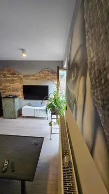 a living room with a wall with a face on it at Odpoczynek w Parku, Free Parking!! in Kraków