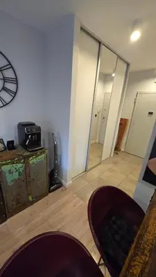 a living room with a clock on the wall at Odpoczynek w Parku, Free Parking!! in Kraków
