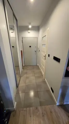 an empty hallway with a door and a tile floor at Odpoczynek w Parku, Free Parking!! in Kraków