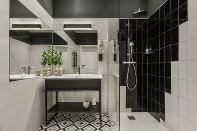 a bathroom with a sink and a shower at White Lotus by Fragola Apartments in Kraków