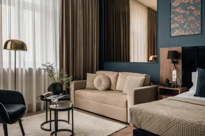 a living room with a couch and a bed at White Lotus by Fragola Apartments in Kraków