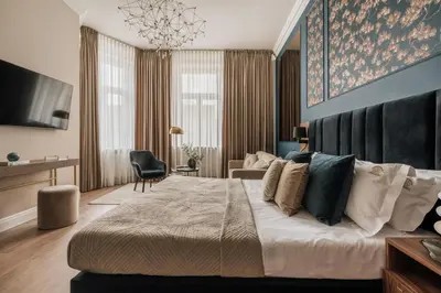 a bedroom with a large bed and a living room at White Lotus by Fragola Apartments in Kraków