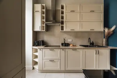 a kitchen with white cabinets and a sink at White Lotus by Fragola Apartments in Kraków