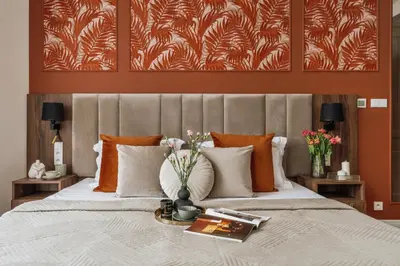 a bedroom with a large bed with orange and white pillows at White Lotus by Fragola Apartments in Kraków