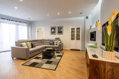 a living room with a couch and a table at Carmel Apartment by Cracovia Prime in Kraków