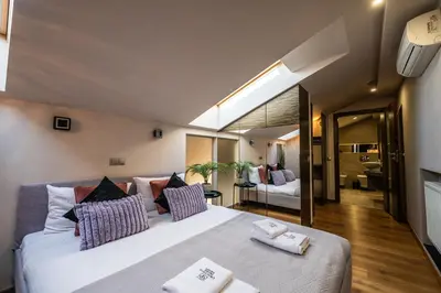 a bedroom with a large bed with towels on it at Boho13 Apartment by Cracovia Prime in Kraków
