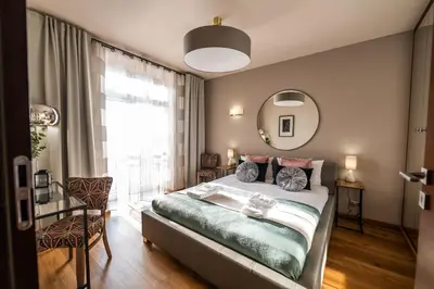 a bedroom with a bed and a large window at Boho13 Apartment by Cracovia Prime in Kraków