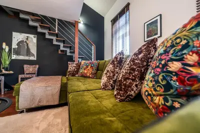 a living room with a green couch with pillows at Boho13 Apartment by Cracovia Prime in Kraków