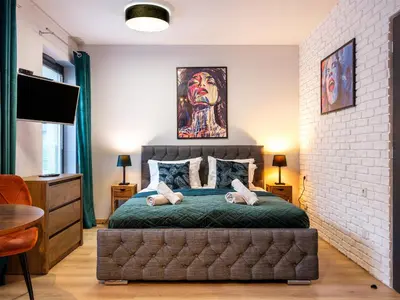 a bedroom with a bed with two stuffed animals on it at Boho and Forest Studios by Tyzenhauz in Kraków