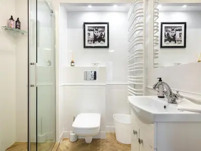 a white bathroom with a toilet and a sink at Boho and Forest Studios by Tyzenhauz in Kraków
