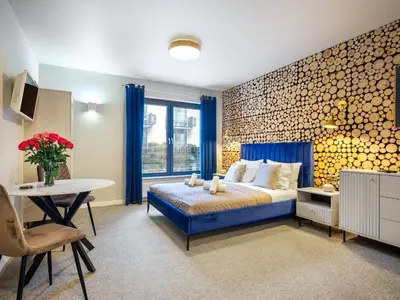 a bedroom with a bed and a desk and a table at Boho and Forest Studios by Tyzenhauz in Kraków