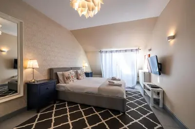 a bedroom with a bed and a large mirror at Meadows9 Apartment by Cracovia Prime in Kraków