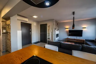 a living room with a couch and a table at Meadows9 Apartment by Cracovia Prime in Kraków