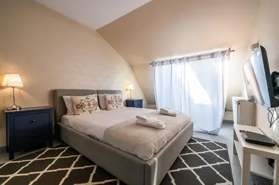 a bedroom with a large bed and a window at Meadows9 Apartment by Cracovia Prime in Kraków