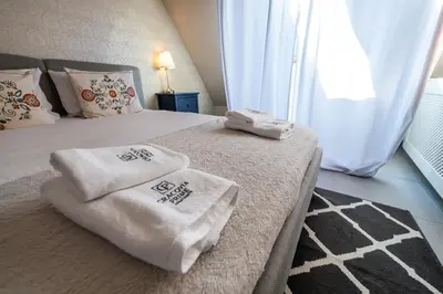 a bedroom with two towels on a bed at Meadows9 Apartment by Cracovia Prime in Kraków