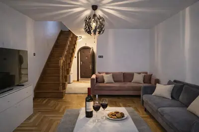 a living room with a couch and a table with wine glasses at Chill Apartment with Jacuzzi in Kraków