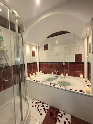 a large bathroom with a tub and a shower at Chill Apartment with Jacuzzi in Kraków