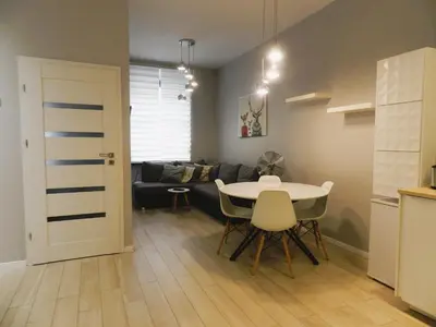 a living room with a table and a couch at Apartament Donnka in Kraków
