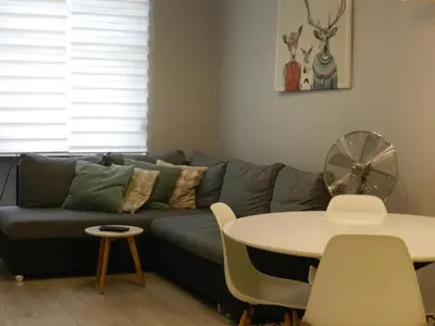 a living room with a couch and a table at Apartament Donnka in Kraków