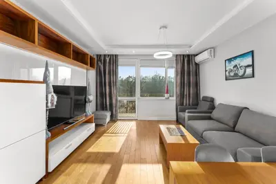 a living room with a couch and a tv at Nowa Huta Charming Apartment by BookingHost in Kraków