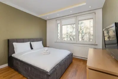 a bedroom with a bed and a window at Nowa Huta Charming Apartment by BookingHost in Kraków