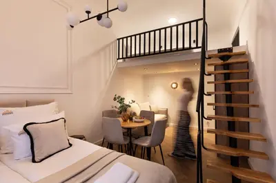 a bedroom with a bunk bed and a spiral staircase at L23 Boutique by Downtown Apartments in Kraków