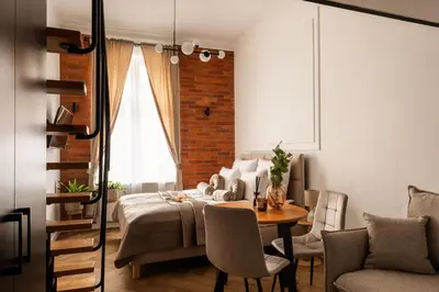 a living room with a bed and a table and chairs at L23 Boutique by Downtown Apartments in Kraków