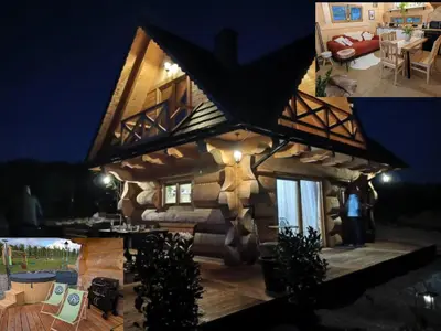 a log cabin with a star on the side of it at Domek Gruszkowy Wzorek in Łącko