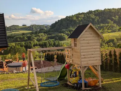 a play set with a house and a playground at Domek Gruszkowy Wzorek in Łącko