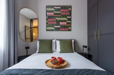 a living room with a couch and a mirror at Amaryllis Apartment by MB Apartments in Kraków