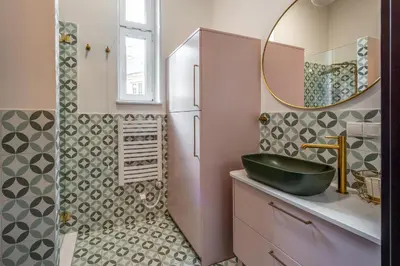 a bathroom with a black sink and a mirror at Amaryllis Apartment by MB Apartments in Kraków
