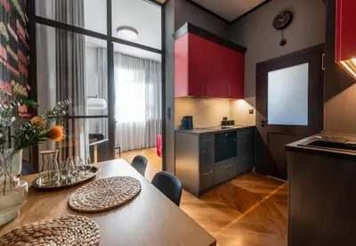 a dining room with a table and a wall of wine bottles at Amaryllis Apartment by MB Apartments in Kraków