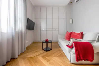a room with a chair and a table and a window at Amaryllis Apartment by MB Apartments in Kraków