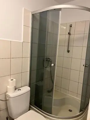 a bed with a pillow and a blanket on it at 4 Couples Hostel in Kraków